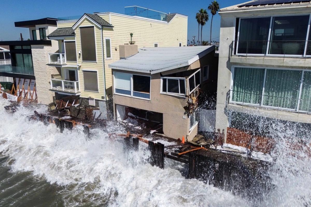Waves shred Long Beach boardwalk as 7-foot storm surge looms Monday